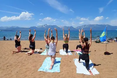a group of people doing yoga on the beach at Cozy 3BDR - 1 Minute to the Beach! in Tahoe Vista