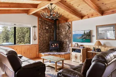 a living room with a couch and a fireplace at Cozy 3BDR - 1 Minute to the Beach! in Tahoe Vista