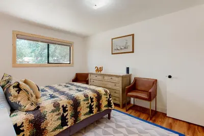 a bedroom with a bed and a dresser and a window at Walling Mountain Retreat in Groveland