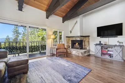 a living room with a fireplace and a television at 10 Mi to Palisades Tahoe! Condo with Game Room in Tahoe City
