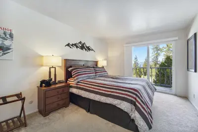 a bedroom with a bed and a window at 10 Mi to Palisades Tahoe! Condo with Game Room in Tahoe City