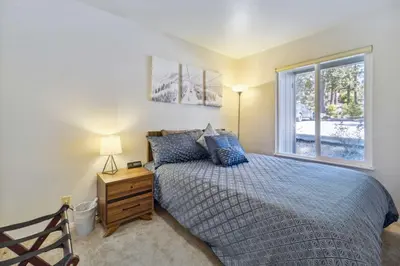 a bedroom with a bed and a window at 10 Mi to Palisades Tahoe! Condo with Game Room in Tahoe City