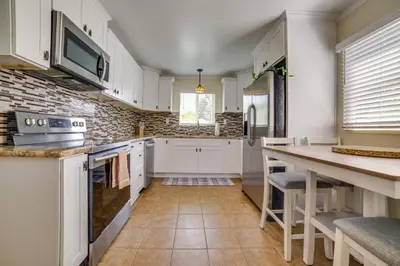 a kitchen with white cabinets and a counter top at Relax Fireside! Tahoe Area Home 28 Mi to Slopes in Carson City