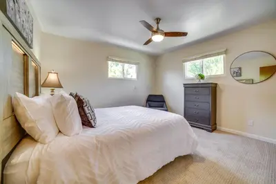 a bedroom with a white bed and a ceiling fan at Relax Fireside! Tahoe Area Home 28 Mi to Slopes in Carson City