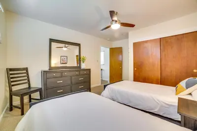 a bedroom with two beds and a dresser and a mirror at Relax Fireside! Tahoe Area Home 28 Mi to Slopes in Carson City