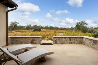 a patio with chairs and a view of a field at Grand Reserve Inn in Plymouth