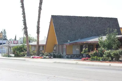 a house on the side of a street at Cinderella Motel in Wasco