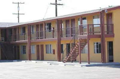 a building with a staircase on the side of it at Cinderella Motel in Wasco