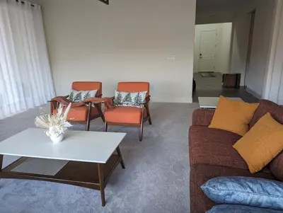 a living room with two chairs and a couch and a table at Modern, Spacious & Relaxing Home in Sparks, NV in Sparks