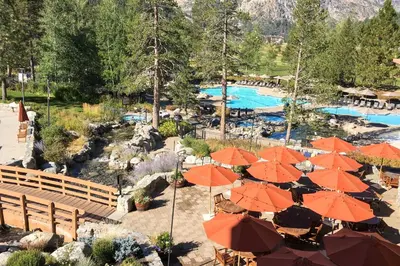 a resort with orange umbrellas and a swimming pool at Resort at Everline Resort & Spa #558 in Olympic Valley