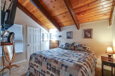 a bedroom with a bed with a wooden ceiling at Pinecrest Dodge Ridge Cabin Shared Outdoor Space in Cold Springs