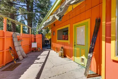 an orange and yellow building with a sidewalk at Dodge Ridge Pinecrest Mountain Cabin Near Hiking! in Cold Springs