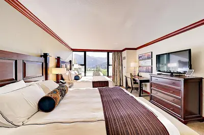 a hotel room with a large bed and a flat screen tv at 556 Everline in Olympic Valley