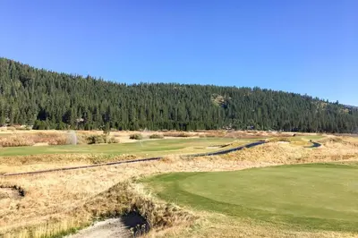 an aerial view of a golf course with trees at 556 Everline in Olympic Valley