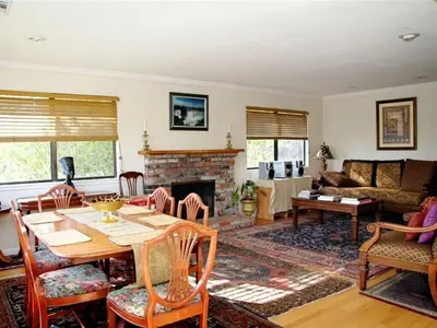 a living room with a table and a fireplace at A Great Riverfront Retreat a Shangri-La Paradize in Valley Springs