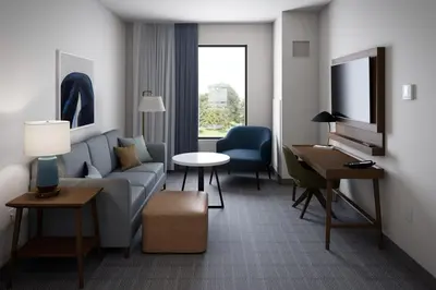 a living room with a couch and a table at Staybridge Suites Manteca by IHG in Manteca