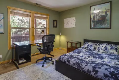 a bedroom with a bed and a desk and a chair at Truckee Retreat with Fireplace and Community Amenities in Truckee