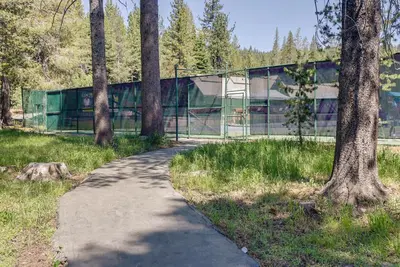 a path in a park with trees and a building at Truckee Retreat with Fireplace and Community Amenities in Truckee