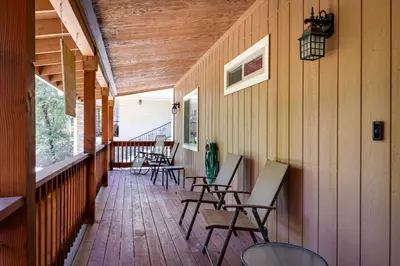 a porch with chairs and tables on a house at Groveland Vacation Rental Near Pine Mountain Lake! in Groveland