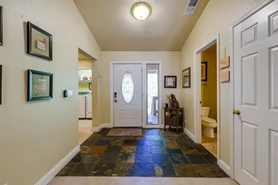 a hallway with a white door and a toilet at Groveland Vacation Rental Near Pine Mountain Lake! in Groveland