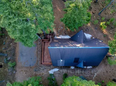 an overhead view of a blue building in the woods at 3BR Tahoe Cabin in the Trees with Hot Tub in Carnelian Bay