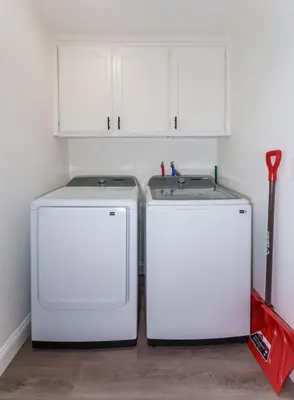 two white refrigerators sitting next to each other in a kitchen at A Modern Hideaway - with hot tub, game room, and more in Oakhurst