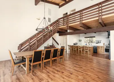 an open kitchen and dining room with a wooden table and chairs at Yosemite Sunrise House with hot tub/views/game room in Oakhurst