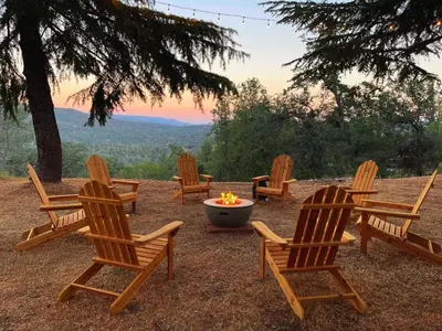 a group of chairs sitting around a fire pit at Yosemite Sunrise House with hot tub/views/game room in Oakhurst