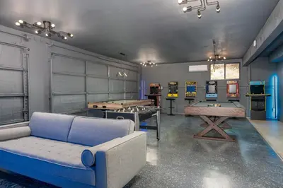 a living room with a couch and ping pong tables at Yosemite Sunrise House with hot tub/views/game room in Oakhurst