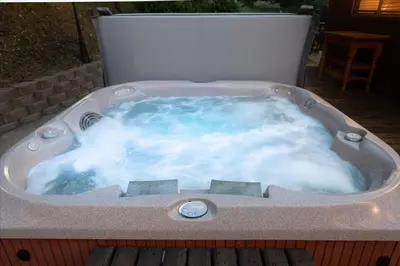 a jacuzzi tub sitting on a deck at Sierra Mountain Escape - Brand new spa/game room in Oakhurst