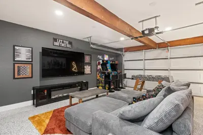a living room with a couch and a tv at Sierra Mountain Escape - Brand new spa/game room in Oakhurst