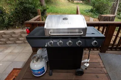 a grill sitting on top of a patio at Sierra Mountain Escape - Brand new spa/game room in Oakhurst