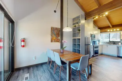 a kitchen and dining room with a wooden table and chairs at Rocky Point Paradise in Truckee