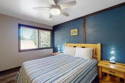 a bedroom with a bed and a ceiling fan at Rocky Point Paradise in Truckee