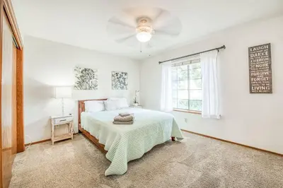 a white bedroom with a bed and a ceiling fan at Stylish 3BR/2BA Retreat w/ Pool! Dream Getaway in Fresno