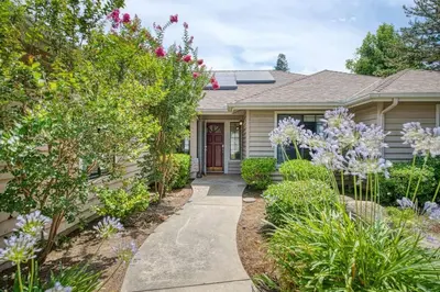 a house with a pathway leading to the front door at Stylish 3BR/2BA Retreat w/ Pool! Dream Getaway in Fresno