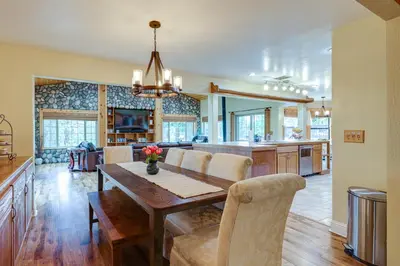 a dining room and kitchen with a table and chairs at Mi-Wuk Village Vacation Rental with Multi-Level Deck in Mi-Wuk Village