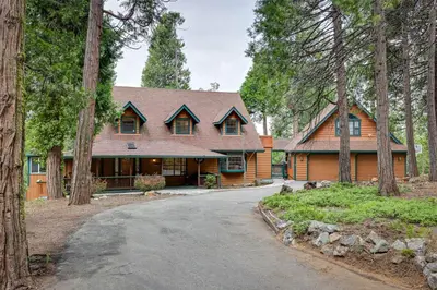 a cabin in the woods with a driveway at Mi-Wuk Village Vacation Rental with Multi-Level Deck in Mi-Wuk Village