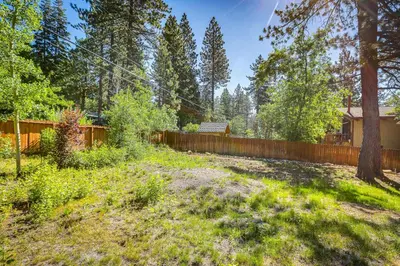 a backyard with a wooden fence and a yard at 2 Mi to Lake Tahoe Spacious and Serene Retreat! in Tahoe City