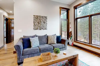 a living room with a couch and a table at Red Mountain Lodge in Truckee