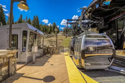 a ski lift car parked next to a train at Snowscape Serenity in Truckee