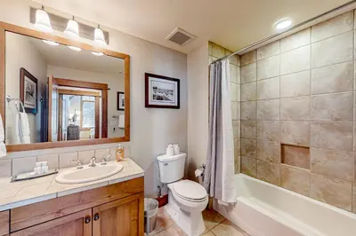 a bathroom with a toilet and a sink and a shower at Snowscape Serenity in Truckee
