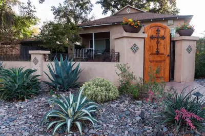 a house with a wooden door and some plants at Sequoia Studio with Private Patio in Visalia
