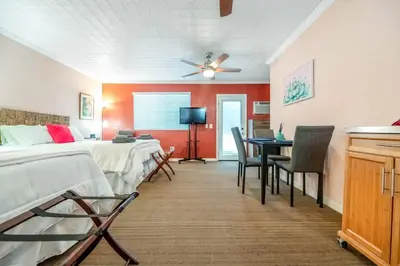 a bedroom with two beds and a table with chairs at Sequoia Studio with Private Patio in Visalia