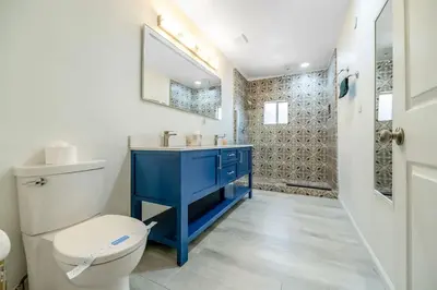 a bathroom with a blue sink and a toilet at Sequoia Studio with Private Patio in Visalia