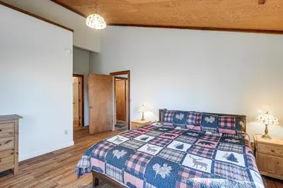 a bedroom with a bed and two lamps and a dresser at Deck and Gas Grill Secluded Arnold Cabin Rental! in Arnold