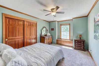 a bedroom with a bed and a ceiling fan at 11 Acre Mountain Spirit Retreat in North Fork