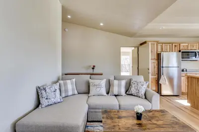 a living room with a couch and a table at Comfy Oakhurst Duplex Near Hiking and Sightseeing! in Oakhurst