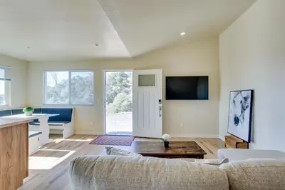 a living room with a couch and a table at Comfy Oakhurst Duplex Near Hiking and Sightseeing! in Oakhurst