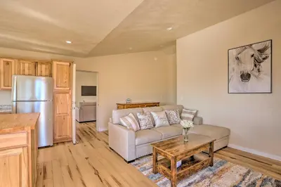 a living room with a couch and a table at Oakhurst Duplex about 13 Mi to Yosemite National Park! in Oakhurst
